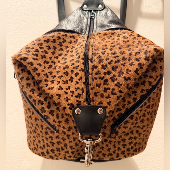 animal print backpack leather Cody JJ Winters 10 inches wide and 7 inches deep Made of polyester canvas Zipper closure Features two adjustable length straps ALAZA Mini Backpack Purse for